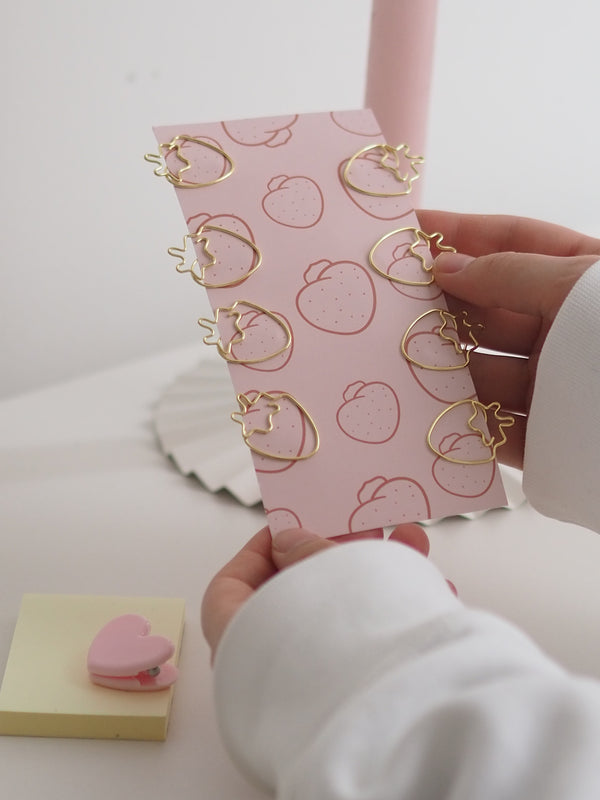 Büroklammer-Set strawberry mit goldenen Erdbeer-Büroklammern auf rosa Karte